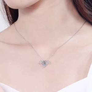 S925 sterling silver angel wing necklace with sparkling moissanite on a model neck