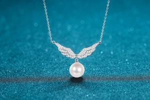 Detail of S925 sterling silver angel wing necklace with sparkling zircon and 10mm pearl