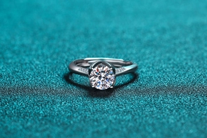 Macro shot of 925 sterling silver moissanite ring with six-claw setting and side stones