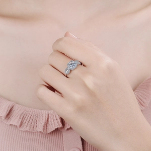 Elegant 925 sterling silver halo moissanite ring with leaf side stones on a finger