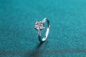 Macro shot of silver S925 ring with moissanite center stone and four-prong setting