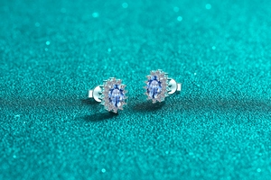 Macro shot of S925 sterling silver sapphire earrings with halo diamond sunflower design