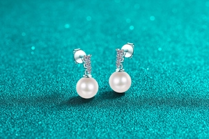 Macro shot of S925 silver pearl drop earrings with sparkling moissanite stones