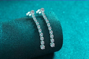 Macro shot of S925 sterling silver drop earrings with shimmering moissanite tassels