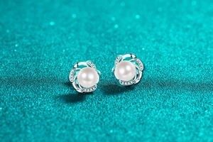 Macro detail of S925 silver flower stud earrings with white pearl and sparkling crystals