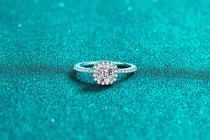 Macro shot of cushion cut moissanite ring with halo setting in polished silver