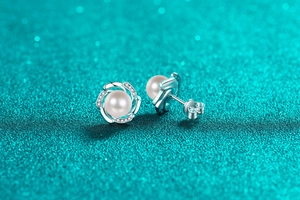 Macro shot of S925 silver flower pearl stud earrings with sparkling moissanite petals