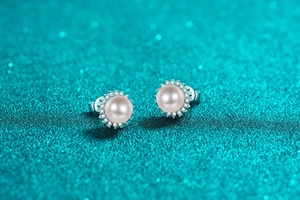 Detail of S925 silver sunflower stud earrings with pearl center and zircon halo