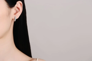 Close-up of S925 sterling silver hoop earrings with micro-set stones on ear lobe
