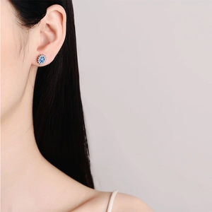 S925 sterling silver halo stud earrings with oval blue gemstone worn on ear