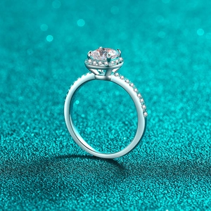 Classic S925 sterling silver halo ring with a 1ct round moissanite on green background