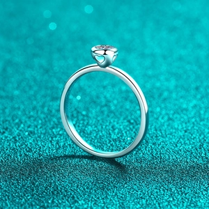 Elegant S925 sterling silver moissanite ring with romantic heart cutout on blue texture
