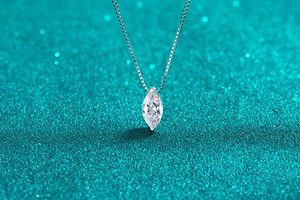 Macro view of marquise-cut moissanite pendant on a silver-plated water drop chain