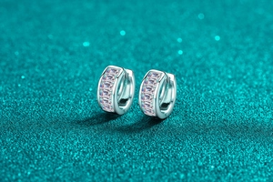 Close-up of S925 silver hoop earrings with baguette-cut moissanite in channel setting