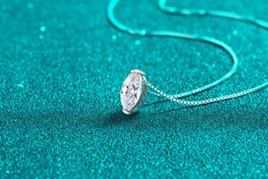 Macro view of marquise-cut moissanite pendant on a S925 silver box chain
