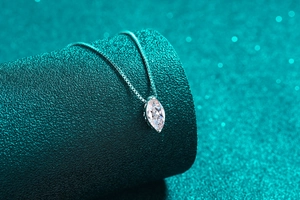 Macro shot of marquise-cut moissanite pendant on elegant S925 silver box chain