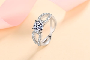 Detailed close-up of a silver infinity moissanite ring with intricate pavé stone accents