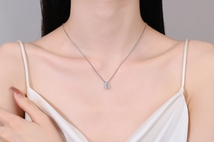 Detailed close-up of S925 silver necklace with marquise cut blue moissanite on neck