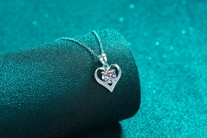 Detailed view of 925 silver heart necklace featuring a large central moissanite stone