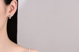 Close-up of S925 silver hoop earring with three rectangle cut light blue moissanite stones