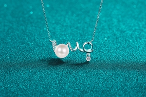 Macro shot of S925 silver LOVE pendant with round pearl and small moissanite accents