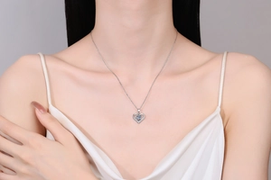 Close-up of 925 silver heart pendant necklace with moissanite stone on a model