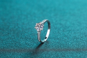 Close-up of a S925 sterling silver ring with a six-prong round moissanite and side stones