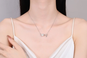 Close-up of S925 silver LOVE pendant necklace with elegant pearl and inlaid diamonds