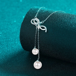 Elegant 925 silver necklace featuring a bow pendant with moissanite and pearl tassels