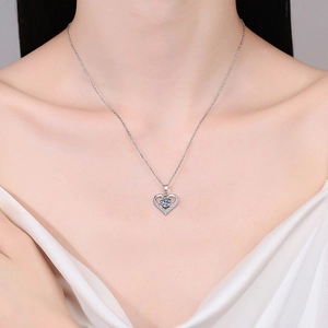Elegant 925 sterling silver heart pendant necklace with moissanite on a female model