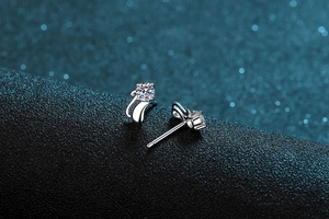 Macro view of S925 sterling silver minimalist cat stud earrings with sparkling moissanite