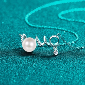 Elegant S925 silver necklace with white pearl and moissanite pendant on a teal background