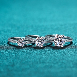 Three-piece set of silver S925 six-prong moissanite rings on a blue texture background
