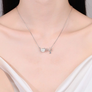 S925 silver LOVE necklace with white pearl and blue gemstone on female model