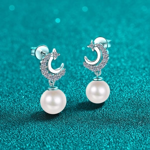 S925 silver moon and star pearl earrings with pavé moissanite on blue background