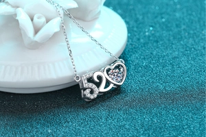 Macro shot of S925 silver 520 heart pendant necklace featuring a central moissanite stone