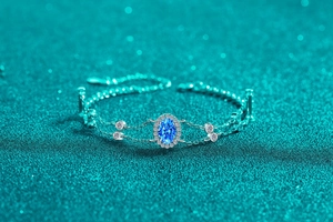 Close-up of 925 silver bracelet with oval blue moissanite stone and halo setting