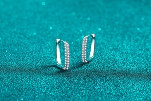 Macro shot of S925 sterling silver rectangular earrings with double-row moissanite stones