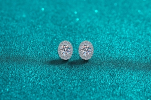 Macro shot of oval S925 sterling silver halo earrings with moissanite stones