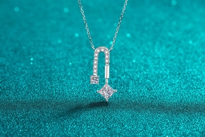 Macro shot of S925 silver necklace featuring square and round moissanite pendant details