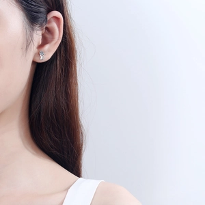 S925 sterling silver moissanite earrings with fluid curved lines worn by a model