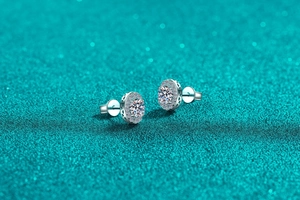 Detail view of oval S925 sterling silver stud earring with moissanite halo and hollow pattern