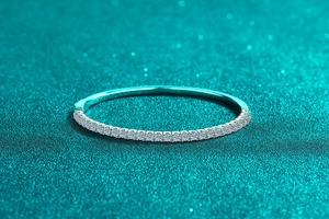 Macro view of slender 925 sterling silver bangle with pavé moissanite stones
