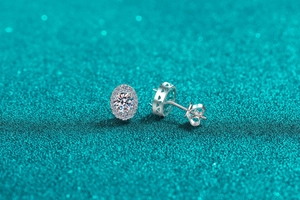 Macro view of S925 silver oval halo stud earrings with detailed side geometric cutouts