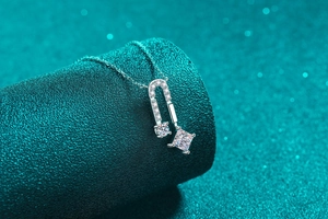Detail of square princess cut stone on a 925 sterling silver horseshoe necklace pendant