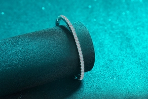 Macro shot of minimalist sterling silver bracelet with pavé-set Moissanite diamonds