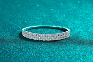 Macro shot of S925 sterling silver bangle with triple-row moissanite stones and high polish