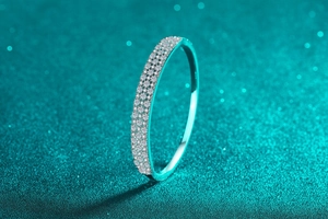 Macro detail of S925 sterling silver bangle with triple-row moissanite stones