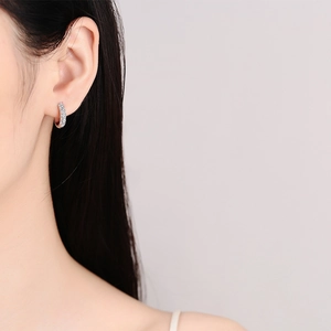 Elegant S925 sterling silver hoop earrings with shimmering moissanite stones on model