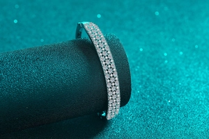 Macro detail of silver S925 bangle featuring full pave set moissanite stones